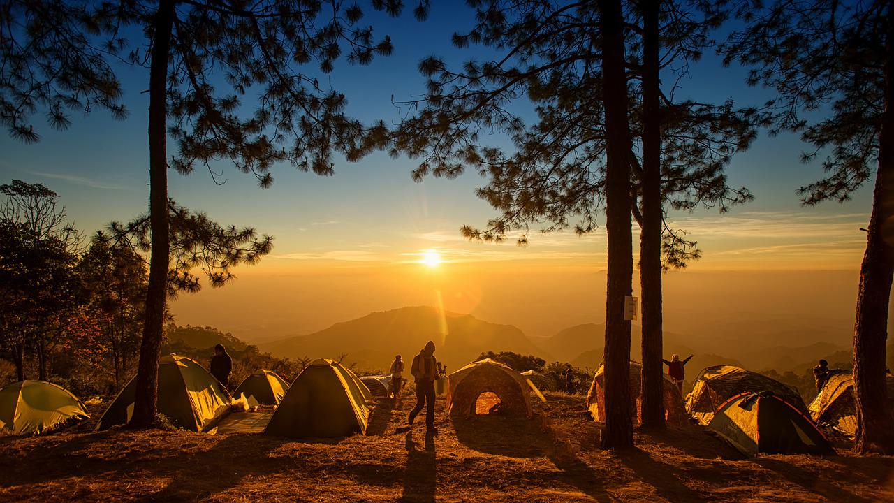 many tents set up for epic camping with friends with a mountain view