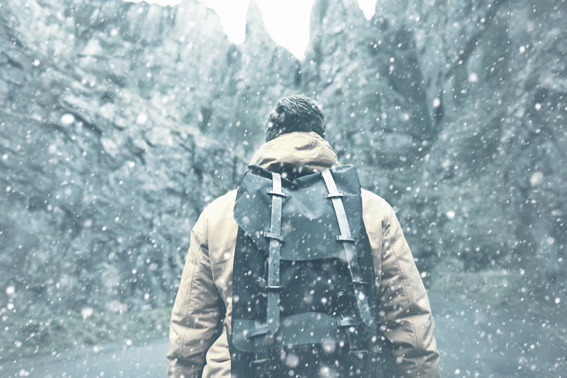 Man hiking in the snow with a backpack on