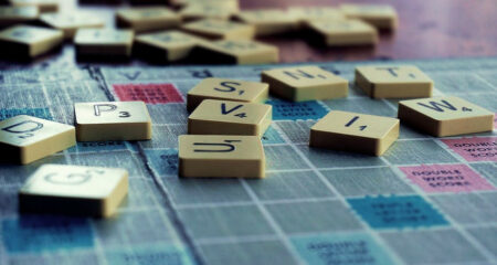 Tiles of the Scrabble Game laying across the board