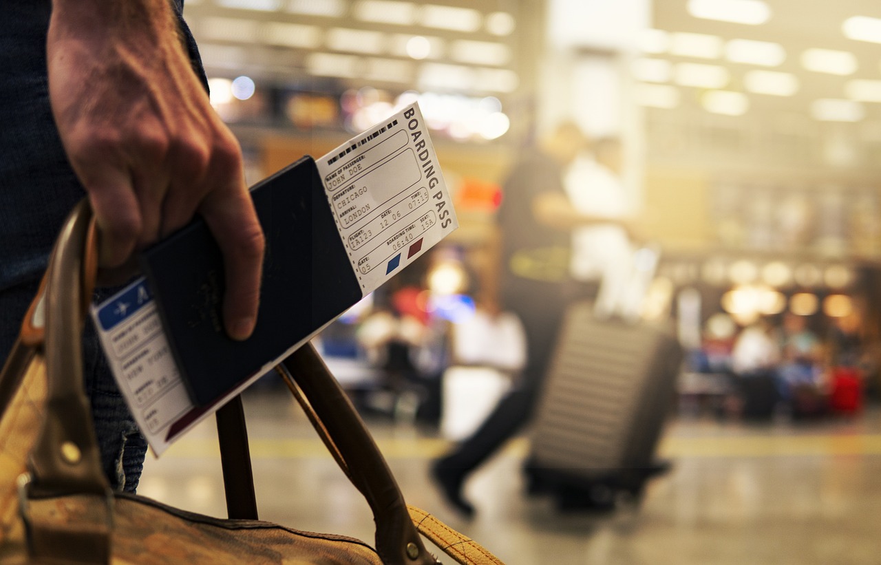 Holding bag and boarding pass in hand